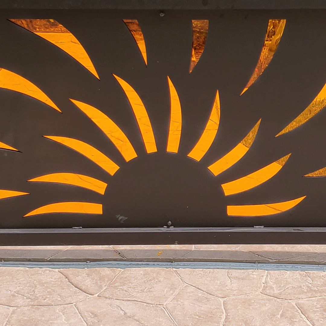 sun with orange rays on a wall